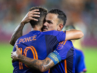 Houston Dynamo forward Ezequiel Ponce (10) and midfielder Jose De Lima Junior ''Artur'' (6) hug after scoring a goal during a match between...