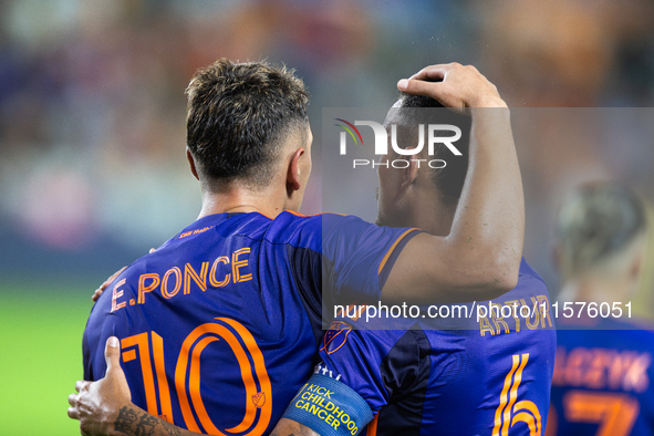 Houston Dynamo forward Ezequiel Ponce (10) and midfielder Jose De Lima Junior ''Artur'' (6) hug after scoring a goal during a match between...