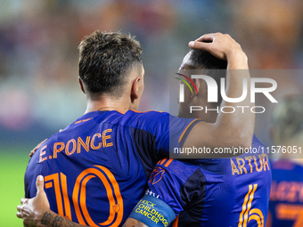 Houston Dynamo forward Ezequiel Ponce (10) and midfielder Jose De Lima Junior ''Artur'' (6) hug after scoring a goal during a match between...