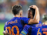 Houston Dynamo forward Ezequiel Ponce (10) and midfielder Jose De Lima Junior ''Artur'' (6) hug after scoring a goal during a match between...