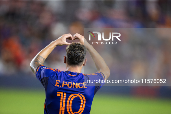 Houston Dynamo forward Ezequiel Ponce (10) makes a heart shape with his hands, a gesture toward his fans, after scoring a goal during a matc...