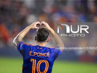 Houston Dynamo forward Ezequiel Ponce (10) makes a heart shape with his hands, a gesture toward his fans, after scoring a goal during a matc...