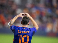 Houston Dynamo forward Ezequiel Ponce (10) makes a heart shape with his hands, a gesture toward his fans, after scoring a goal during a matc...