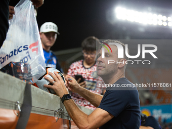 Houston Dynamo coach Ben Olsen signs a soccer ball for young fans after a match between Houston Dynamo and Real Salt Lake at Shell Energy St...