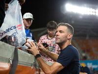 Houston Dynamo coach Ben Olsen signs a soccer ball for young fans after a match between Houston Dynamo and Real Salt Lake at Shell Energy St...