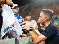 Houston Dynamo coach Ben Olsen signs a soccer ball for young fans after a match between Houston Dynamo and Real Salt Lake at Shell Energy St...