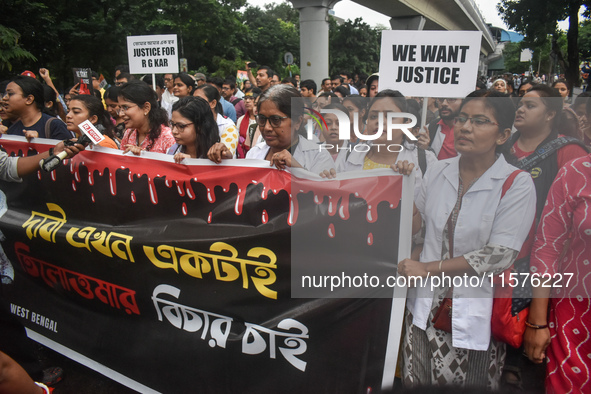 Medical workers march along a street during a protest condemning the rape and murder of a trainee medic at a government-run hospital in Kolk...