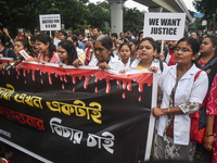 Medical workers march along a street during a protest condemning the rape and murder of a trainee medic at a government-run hospital in Kolk...