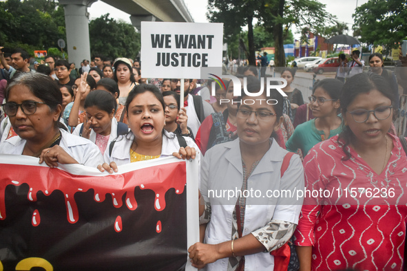 Medics chant slogans as they attend a protest condemning the rape and murder of a trainee medic at a government-run hospital in Kolkata, Ind...