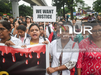 Medics chant slogans as they attend a protest condemning the rape and murder of a trainee medic at a government-run hospital in Kolkata, Ind...