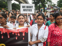 Medics chant slogans as they attend a protest condemning the rape and murder of a trainee medic at a government-run hospital in Kolkata, Ind...