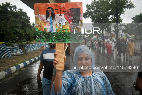 Citizens march along a street during a protest condemning the rape and murder of a trainee medic at a government-run hospital in Kolkata, In...