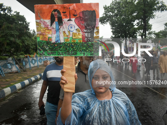 Citizens march along a street during a protest condemning the rape and murder of a trainee medic at a government-run hospital in Kolkata, In...