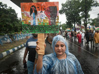 Citizens march along a street during a protest condemning the rape and murder of a trainee medic at a government-run hospital in Kolkata, In...