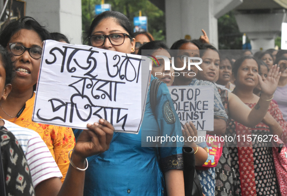 Women march along a street during a protest condemning the rape and murder of a trainee medic at a government-run hospital in Kolkata, India...