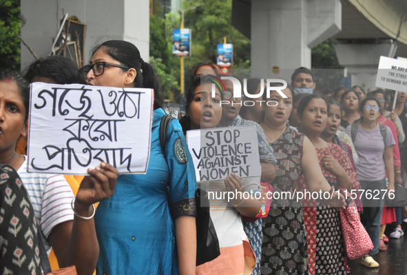 Women march along a street during a protest condemning the rape and murder of a trainee medic at a government-run hospital in Kolkata, India...