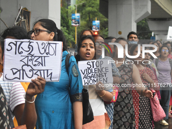 Women march along a street during a protest condemning the rape and murder of a trainee medic at a government-run hospital in Kolkata, India...