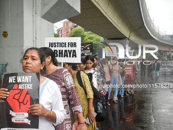 Women march along a street during a protest condemning the rape and murder of a trainee medic at a government-run hospital in Kolkata, India...