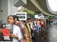 Women march along a street during a protest condemning the rape and murder of a trainee medic at a government-run hospital in Kolkata, India...