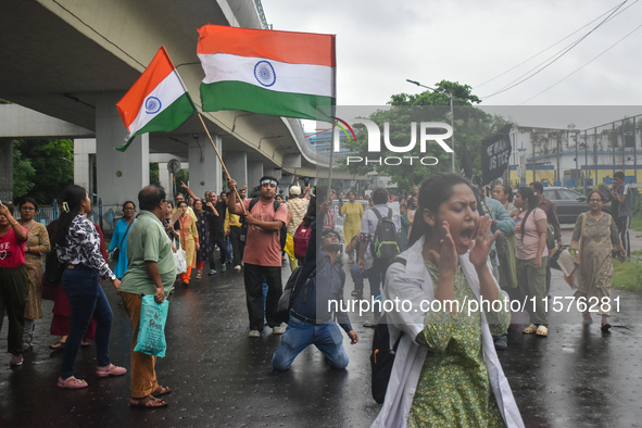 Medics chant slogans as they attend a protest condemning the rape and murder of a trainee medic at a government-run hospital in Kolkata, Ind...