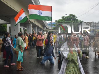 Medics chant slogans as they attend a protest condemning the rape and murder of a trainee medic at a government-run hospital in Kolkata, Ind...