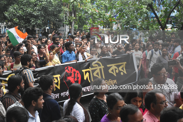 Medics march along a street during a protest condemning the rape and murder of a trainee medic at a government-run hospital in Kolkata, Indi...