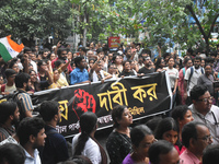 Medics march along a street during a protest condemning the rape and murder of a trainee medic at a government-run hospital in Kolkata, Indi...