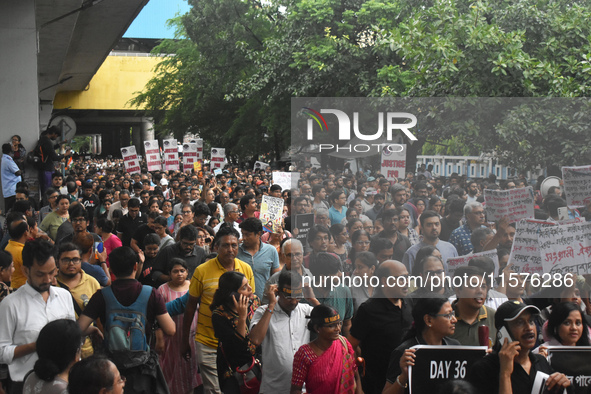 Citizens march along a street during a protest condemning the rape and murder of a trainee medic at a government-run hospital in Kolkata, In...