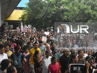 Citizens march along a street during a protest condemning the rape and murder of a trainee medic at a government-run hospital in Kolkata, In...