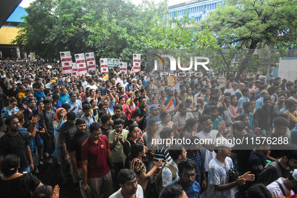 Citizens march along a street during a protest condemning the rape and murder of a trainee medic at a government-run hospital in Kolkata, In...