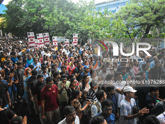 Citizens march along a street during a protest condemning the rape and murder of a trainee medic at a government-run hospital in Kolkata, In...