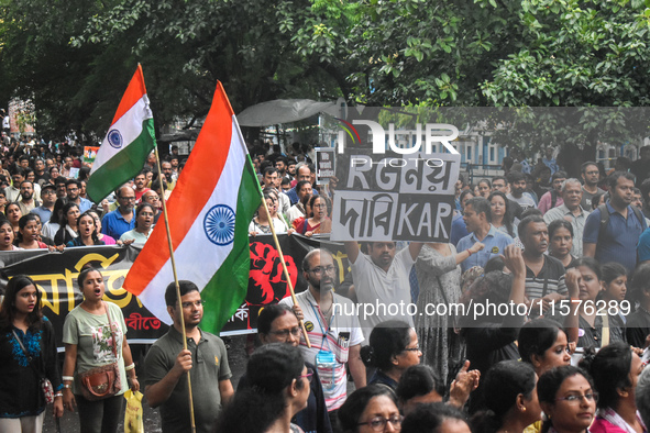 Citizens march along a street during a protest condemning the rape and murder of a trainee medic at a government-run hospital in Kolkata, In...