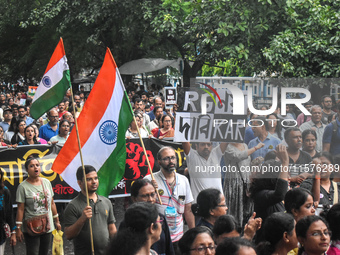 Citizens march along a street during a protest condemning the rape and murder of a trainee medic at a government-run hospital in Kolkata, In...