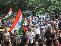 Citizens march along a street during a protest condemning the rape and murder of a trainee medic at a government-run hospital in Kolkata, In...