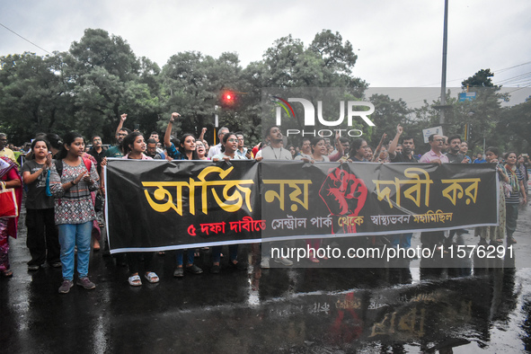 Citizens march along a street during a protest condemning the rape and murder of a trainee medic at a government-run hospital in Kolkata, In...