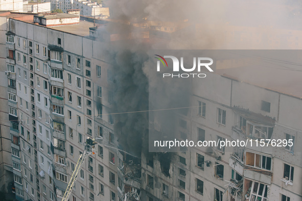 Firefighters extinguish a high-rise building that is hit by an aerial bomb, in Kharkiv, Ukraine, on September 15, 2024. 