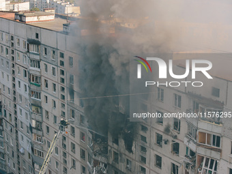 Firefighters extinguish a high-rise building that is hit by an aerial bomb, in Kharkiv, Ukraine, on September 15, 2024. (