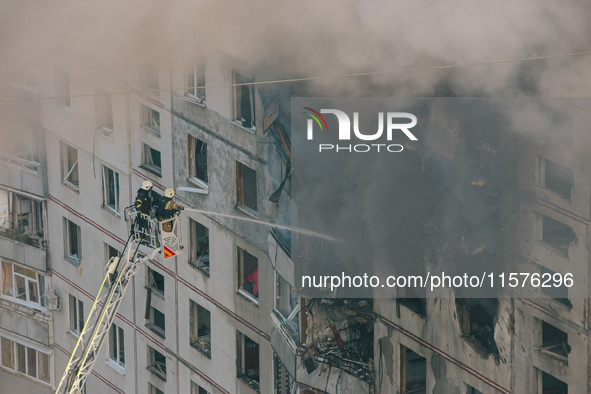 Firefighters extinguish a high-rise building that is hit by an aerial bomb, in Kharkiv, Ukraine, on September 15, 2024. 