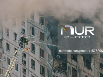 Firefighters extinguish a high-rise building that is hit by an aerial bomb, in Kharkiv, Ukraine, on September 15, 2024. (