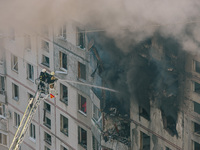 Firefighters extinguish a high-rise building that is hit by an aerial bomb, in Kharkiv, Ukraine, on September 15, 2024. (