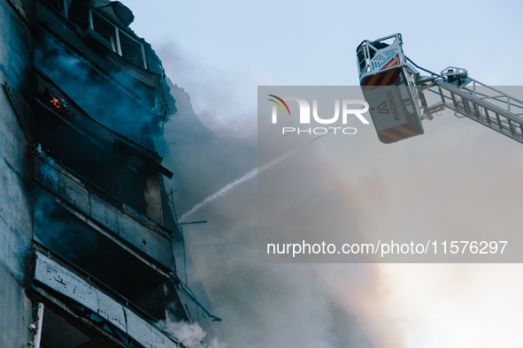 Firefighters extinguish a high-rise building that is hit by an aerial bomb, in Kharkiv, Ukraine, on September 15, 2024. 