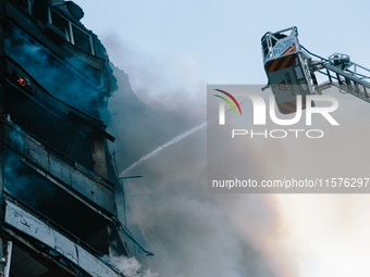 Firefighters extinguish a high-rise building that is hit by an aerial bomb, in Kharkiv, Ukraine, on September 15, 2024. (