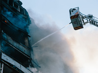 Firefighters extinguish a high-rise building that is hit by an aerial bomb, in Kharkiv, Ukraine, on September 15, 2024. (