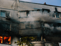 A man in a fire trap waits for rescuers to help him from the roof, in Kharkiv, Ukraine, on September 15, 2024. (