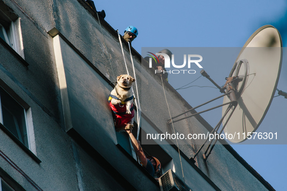 Firefighters extinguish a high-rise building that is hit by an aerial bomb, in Kharkiv, Ukraine, on September 15, 2024. 