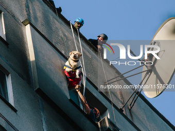 Firefighters extinguish a high-rise building that is hit by an aerial bomb, in Kharkiv, Ukraine, on September 15, 2024. (