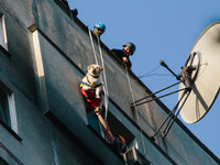 Firefighters extinguish a high-rise building that is hit by an aerial bomb, in Kharkiv, Ukraine, on September 15, 2024. (