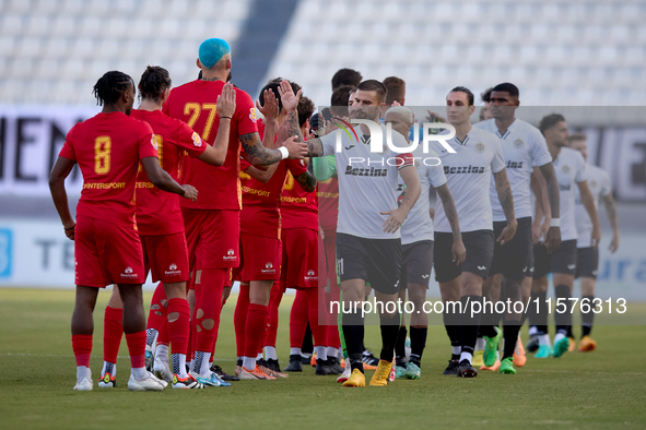 Soccer players from Birkirkara and Hibernians perform the ''high-five'' gesture with each other prior to the Malta 360 Sports Premier League...