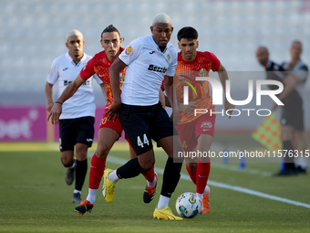 In Ta' Qali, Malta, on September 14, 2024, Nunes Silva Pedro Henrique of Hibernians moves forward with the ball ahead of Alexander Satariano...