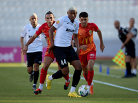 In Ta' Qali, Malta, on September 14, 2024, Nunes Silva Pedro Henrique of Hibernians moves forward with the ball ahead of Alexander Satariano...